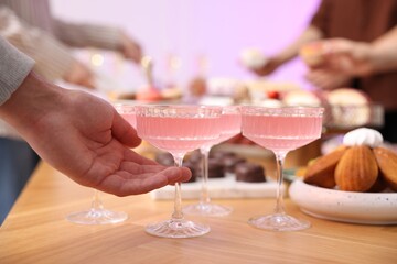People taking drinks and delicious desserts from buffet table, selective focus