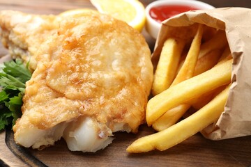 British Traditional Fish and chips on wooden board, closeup