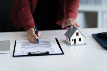 consultant reviews home loan calculations and contract valuation at office