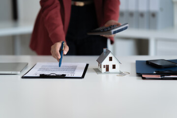 financial expert reviews house contract and loan calculation in office