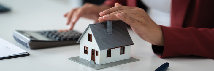 financial expert reviews house contract and loan calculation in office