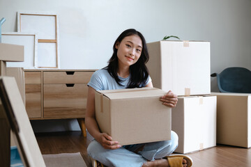 Asian woman packing belongings to prepare for moving out of home