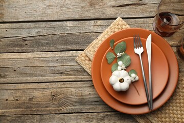 Beautiful table setting with autumn decor on wooden background, flat lay. Space for text