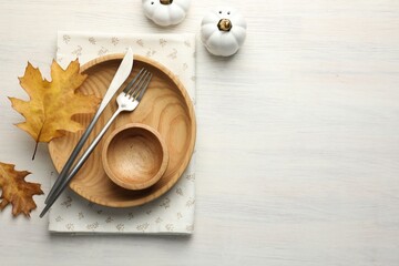 Beautiful table setting with autumn decor on white wooden background, flat lay. Space for text
