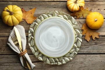 Beautiful table setting with autumn decor on wooden background, flat lay