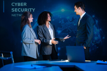 Colleagues brainstorming and sharing ideas in a modern tech office with a cybersecurity background.