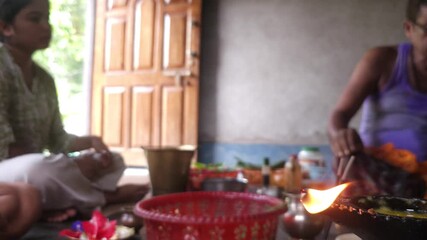 Close-up of Shivling pooja with milk, flowers, and bael leaves being offered. Indian people performing sacred havan on the occasion of Mahashivratri, offering ghee to the holy fire during  Vedic puja.