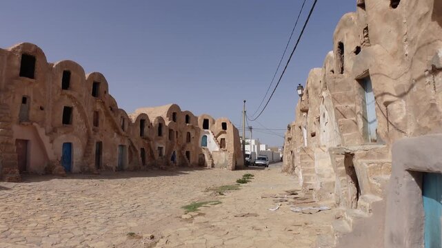 Walking through abandoned historic ksar complex (partly used as a storage facility for the local bazaar) in city of Medenine, Tunisia
