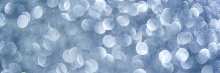 Abstract blue and white bokeh light circles blurred background.