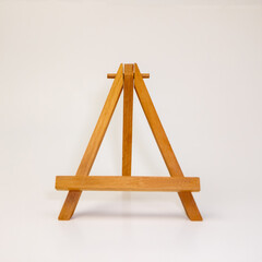 Small wooden tabletop easel for artists on a white background