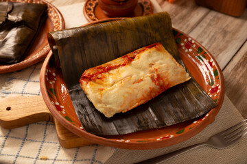 Oaxacan Tamales. A pre-Hispanic dish typical of Mexico and some Latin American countries. Corn dough wrapped in banana leaves is filled with meat or a stew. Tamales are steamed.