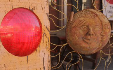 Red Light Next to a Sun and Moon Decoration at Thrift Shop