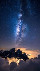 Majestic nighttime landscape with the Milky Way galaxy above rugged mountains