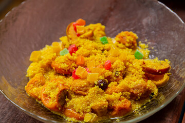 Steamed couscous with dried hands, nuts, and turmeric