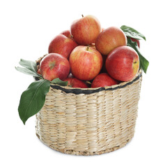 Fresh apples in wicker basket and green leaves isolated on white