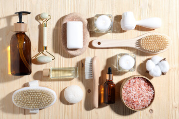 Flat lay composition with spa products and burning candles on wooden table
