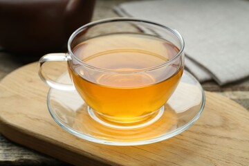 Aromatic black tea in glass cup on table, closeup
