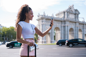 Woman tourist taking selfie in madrid street