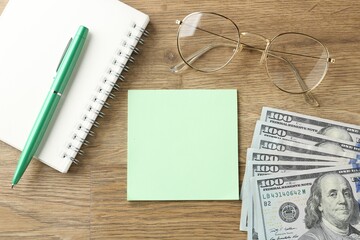 Alimony. Sticky note, money, notebook, pen and glasses on wooden table, flat lay