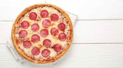 Delicious pepperoni pizza on white wooden background, top view. Space for text