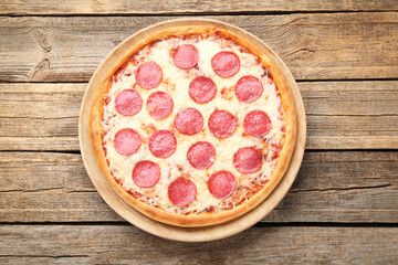 Delicious pepperoni pizza on wooden table, top view