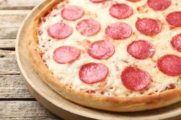 Delicious pepperoni pizza on wooden table, closeup