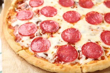 Delicious baked pepperoni pizza on table, closeup