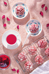 Top view of cookies with flower tea and raspberry jam, flat lay. Cookies on a metal cooling rack