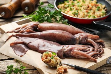 Raw squids, stuffing and parsley on wooden table, closeup