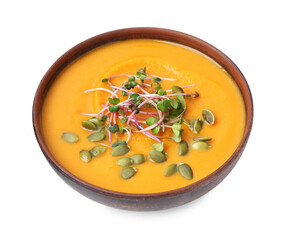 Delicious pumpkin soup with seeds and microgreens in bowl on white background