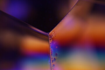 Bright rainbow reflection of liquid in macro, surrealistic background, fantastic smooth movement, water surface, interference pattern