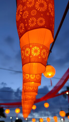 Glowing Orange Paper Lanterns at Dusk, Festival Lights with Floral Patterns Against Twilight Sky