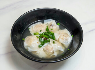 Shaoxing Vegetable and Wood Ear Mushroom Dumplings Steamed Chinese Dim Sum in black bowl on marble background top view