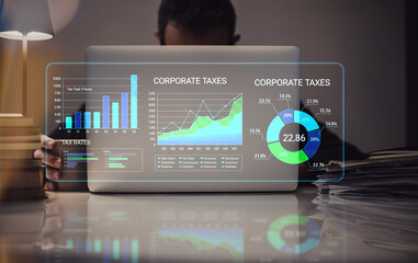 Optimizing Financial Strategy: A Professional Analyzes Corporate Tax Data on a Transparent Screen