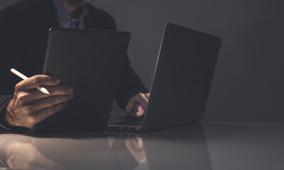 Strategic Creation: A Focused Professional Uses a Stylus and Tablet for Creative Digital Work