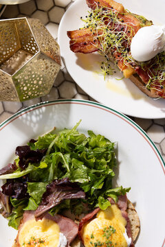 brunch at a moroccan theme restaurant with fusion shakshuka, eggs benedict, salad, and bread
