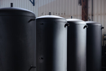 Production of boilers in an industrial setting with sleek black designs