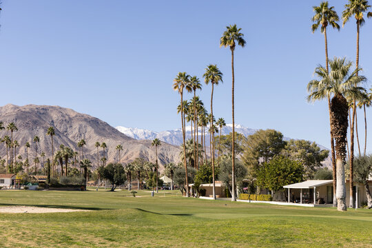 Golf courses in Palm Springs on a sunny day with mountain landscape in the background 