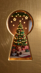 Christmas tree with gifts seen through golden keyhole