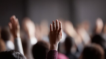 Vibrant side view of a multi-ethnic audience attentively seated, numerous hands raised to interact with a speaker after an inspiring master class. Modern venue.