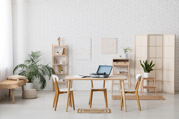 Interior of stylish living room with record player and vinyl disks on wooden table
