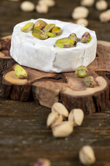 delicious white soft cheese in mold and a large number of salted pistachios with and without cracked shells