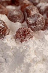 dried kumquat and powdered white sugar, sweet dried orange kumquat fruits in white powdered sugar