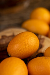 fresh kumquat fruits on the table, fresh orange kumquats , close up