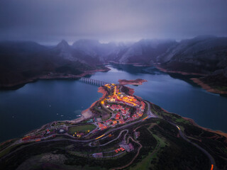 Aerial View of Mountain Village by the Lake at Dusk in Riaño León