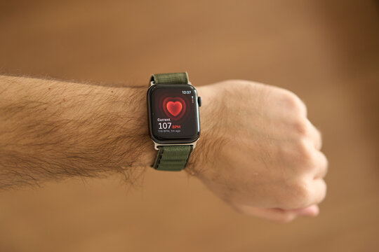 A square smartwatch on a man's hand close up. Heart rate measurement on watch. High quality photo