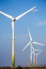 Fototapeta premium White wind turbines stand on the coast