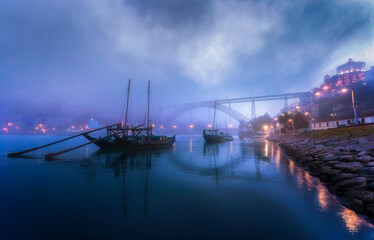 Traditional Boats and Dom Luís I Bridge in Fog, Porto, Portugal
