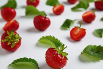 Sweet ripe strawberries with leaves on white background