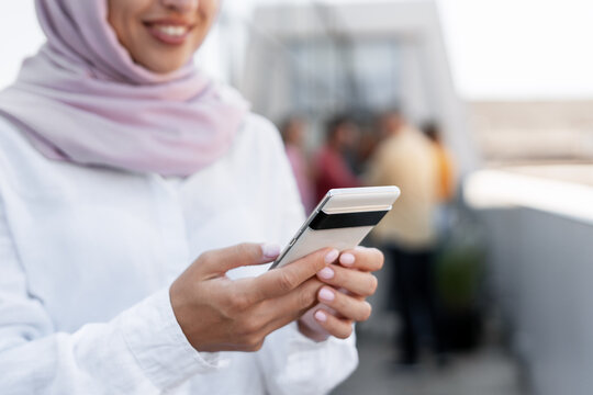 Muslim woman using smartphone for social media networking